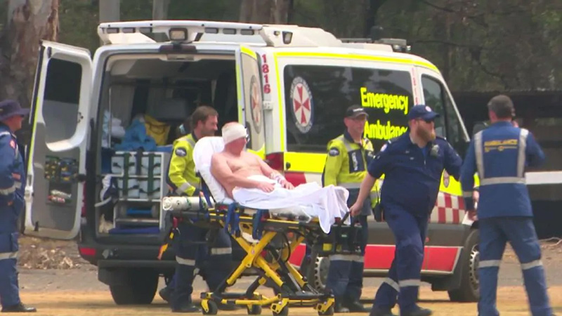 A male firefighter is loaded into a Careflight chopper after sustaining injuries during the Bargo bushfires. Picture: TNV