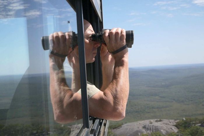 PHOTO: No time for reading anything except the landscape: an observer scans the WA wilderness for smoke. (ABC South West WA: Mark Bennett)