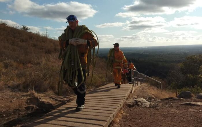 Kalamunda Volunteer Bush Fire Brigade members cleaning up after a dangerous fire at Lesmurdie Falls in Western Australia in January 2020