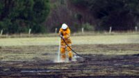 A volunteer firefighter mops up after a fire. Credit: Laurie Benson/Albany Advertiser