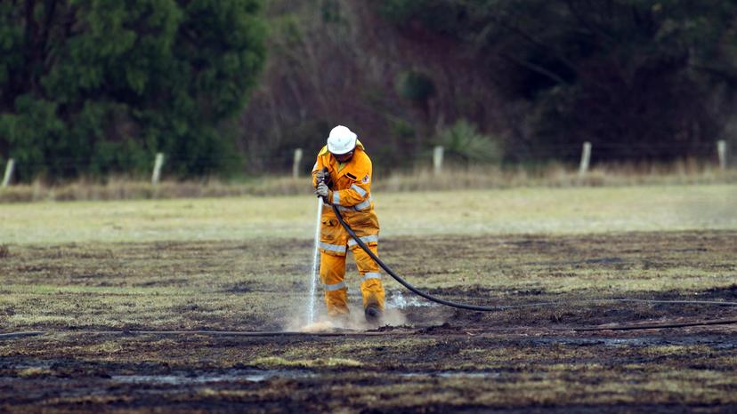 A volunteer firefighter mops up after a fire. Credit: Laurie Benson/Albany Advertiser